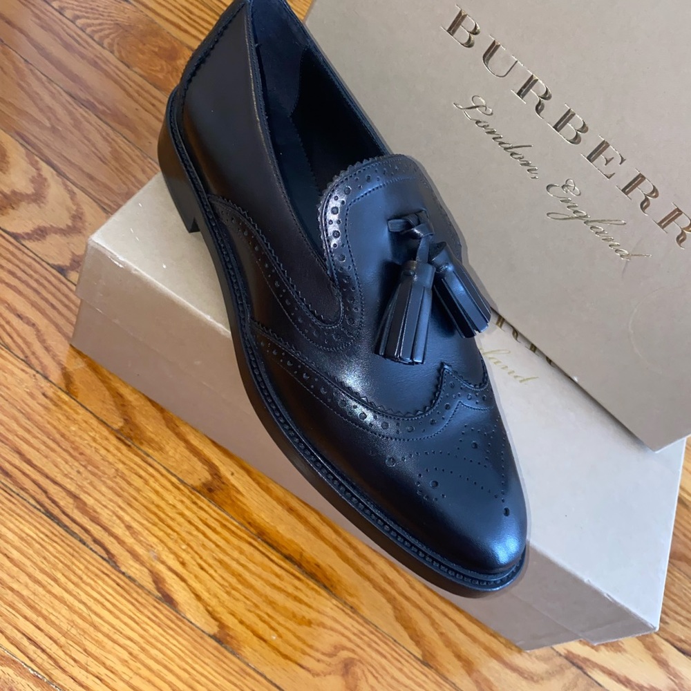 All black wingtip leather loafers